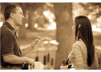 two people talking outdoors