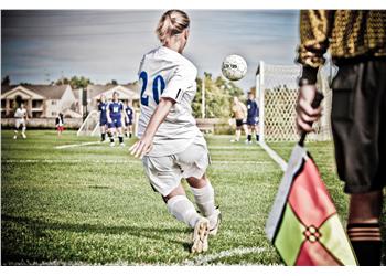 soccer player kicking the ball