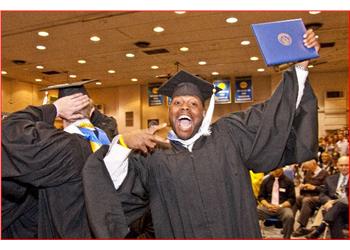 graduate cheering with diploma