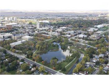 aerial view of campus with lake and buildings