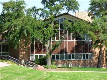 glass-front building amidst greenery