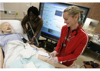 nursing students practice on a mannequin