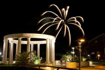 fireworks over a colonnade at night