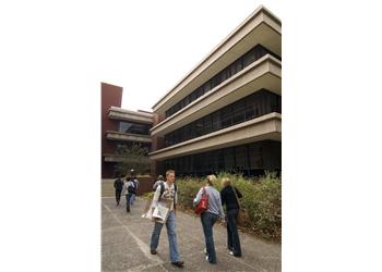 students walking by a university building