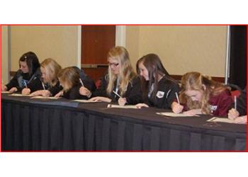 group of students writing at a table