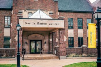 entrance to 'Ancilla Domini College' with a yellow banner