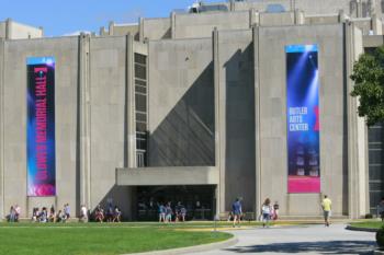 students outside a building with banners