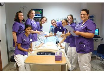 nursing students practicing in a simulation lab