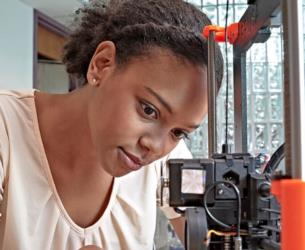 student working with a 3d printer