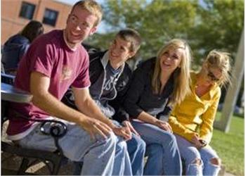 students sitting outdoors on campus