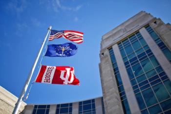 american and hoosiers flags flying above building