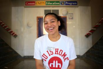 student smiling wearing iu is home shirt