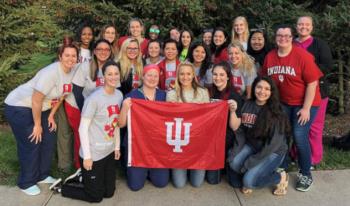 group holding indiana university flag