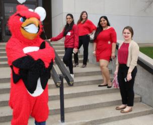 mascot with students on stairs