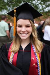 graduate smiling in cap and gown