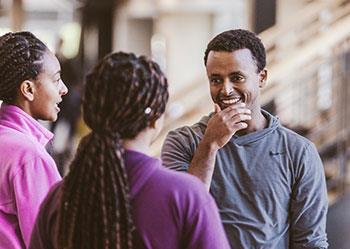 three people chatting outdoors