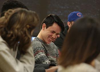 student smiling while studying in class