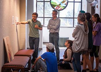 teacher presenting to students at whiteboard