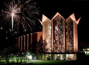 illuminated stained glass building with fireworks in the sky