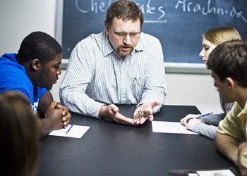 professor teaching students with visual aids