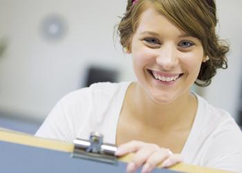 smiling student at a drawing board