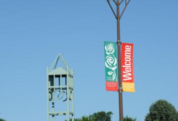 clock tower with 'welcome' banner and a clear blue sky