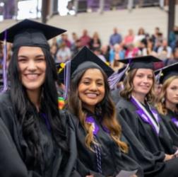 graduates smiling at ceremony