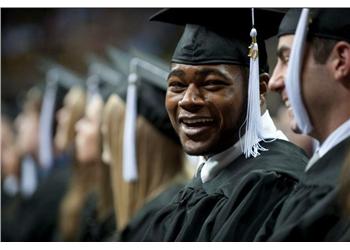 graduates smiling in caps and gowns