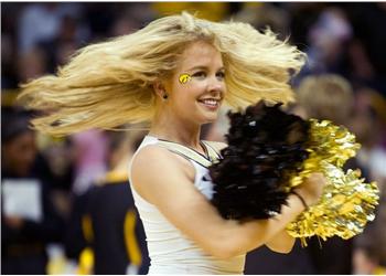 cheerleader with pom-poms mid-twirl