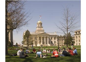 students lounging on grass in front of capitol