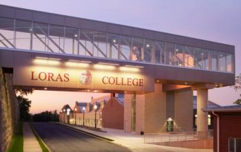 loras college entrance sign at dusk