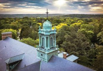 aerial view of campus building with ornate dome at sunset