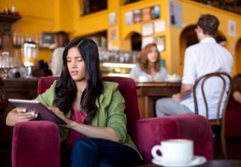 woman using tablet in a coffee shop