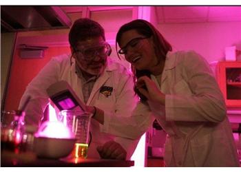 two people in lab coats conducting an experiment