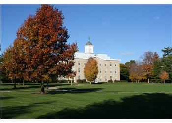 historic building with a cupola among autumn trees