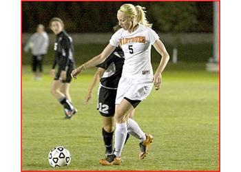 female soccer player in white with 'waburg 5'