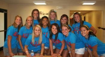 group of people in matching blue t-shirts smiling