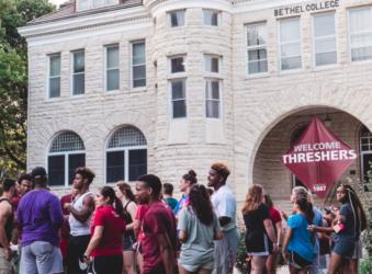 students gather outside 'bethel college' building entrance