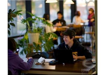 students in a cafe with laptops at emporia state university