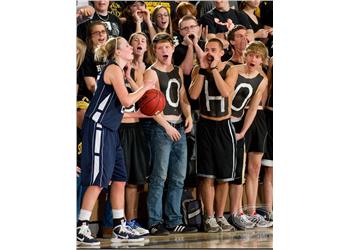 enthusiastic students cheering at a basketball game