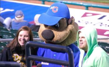 mascot interacting with fans at a baseball game