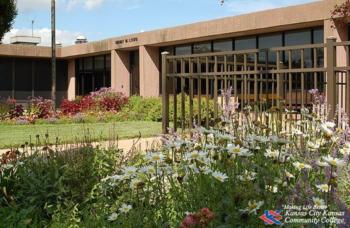 flowers in front of a campus building with clear skies