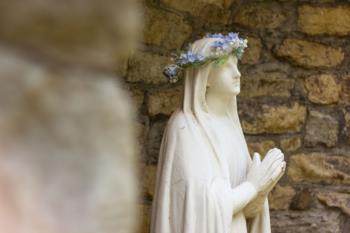 statue with flower crown on campus