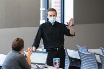 man in mask teaching in classroom