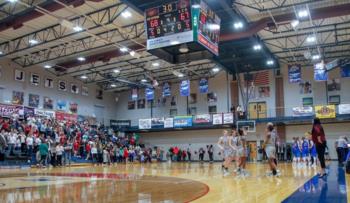 basketball game in gymnasium