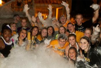 group of students celebrating in foam