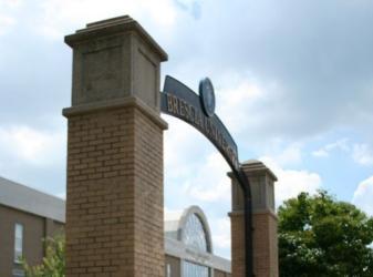 brick archway with 'brescia university' sign