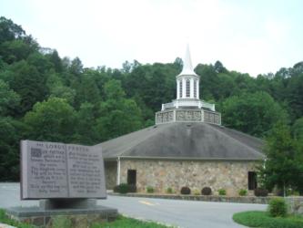 church with a steeple behind an information plaque