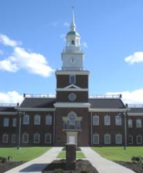 brick building with clock tower under blue sky