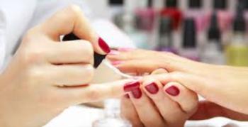 close-up of a manicure process with red nail polish